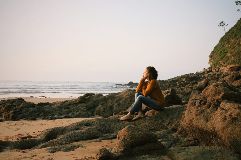 woman sitting on rocks